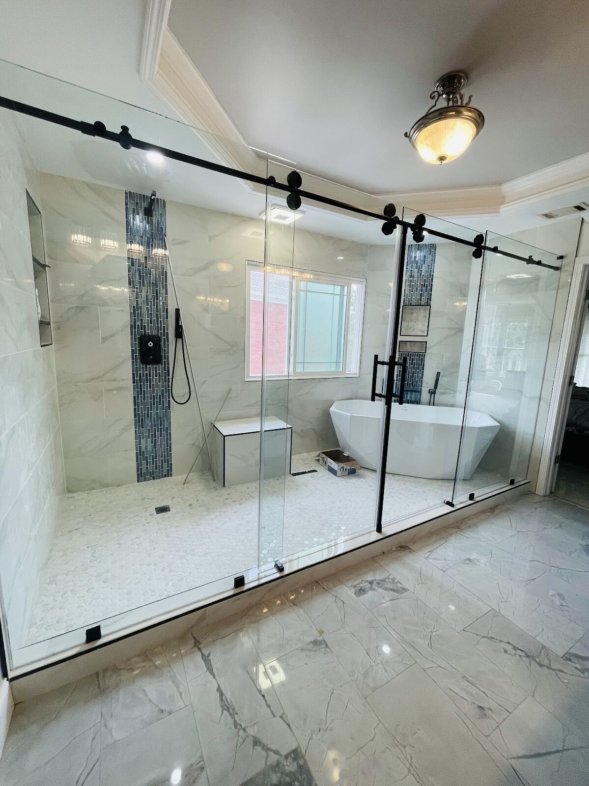 Barn-door enclosure · marble bath